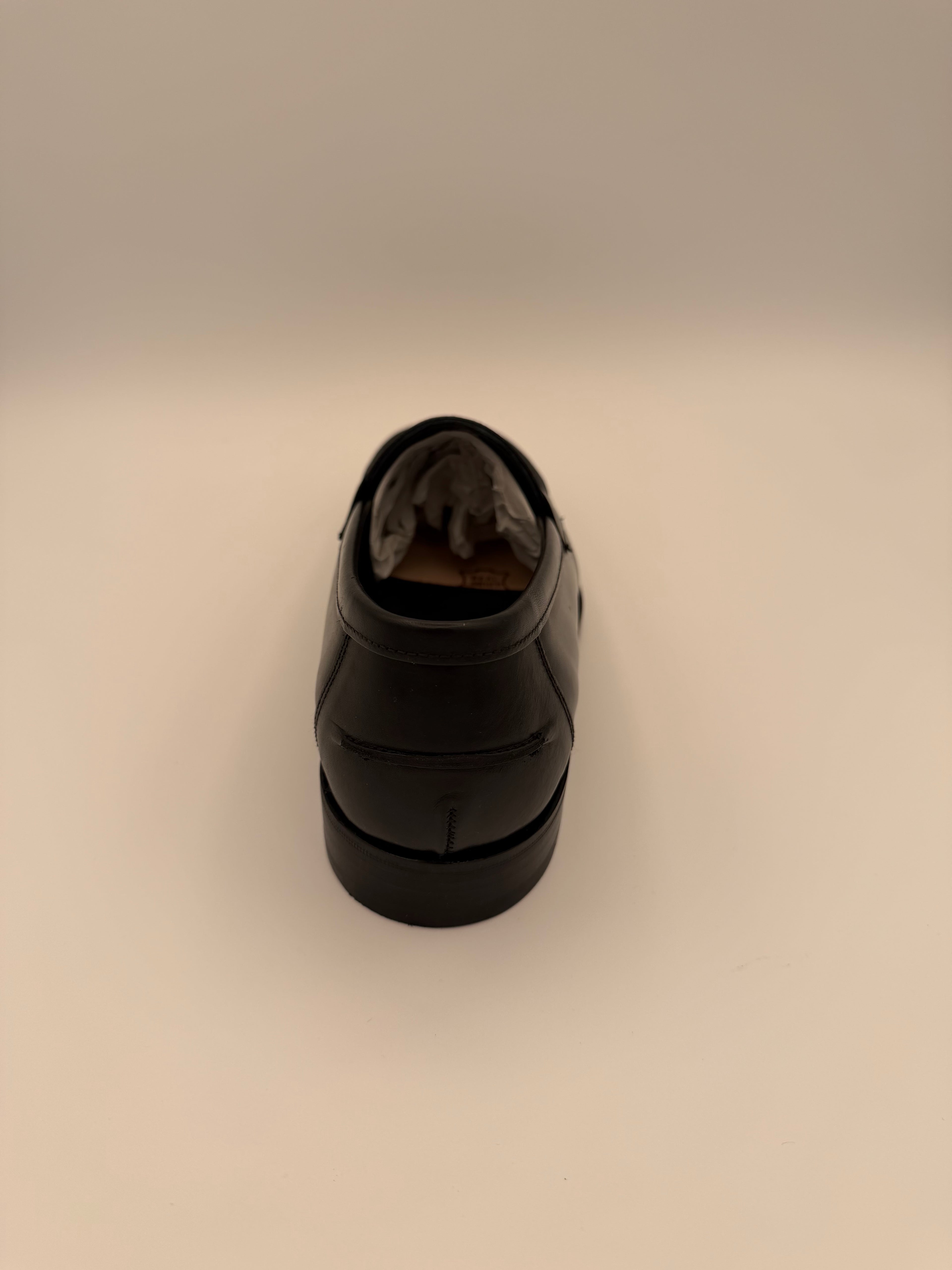 Black cylindrical object on a beige background