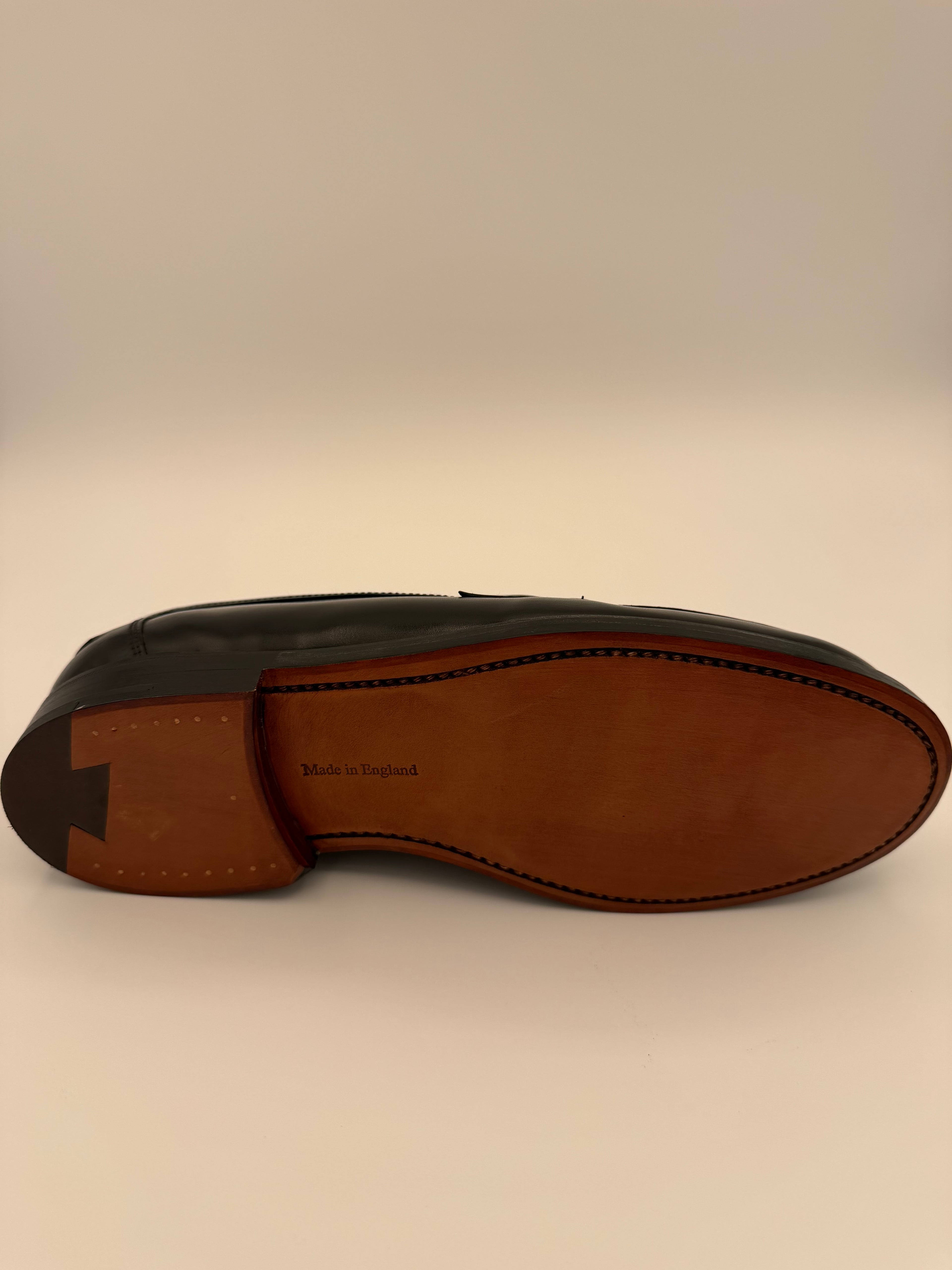 Brown leather shoe sole on a beige background