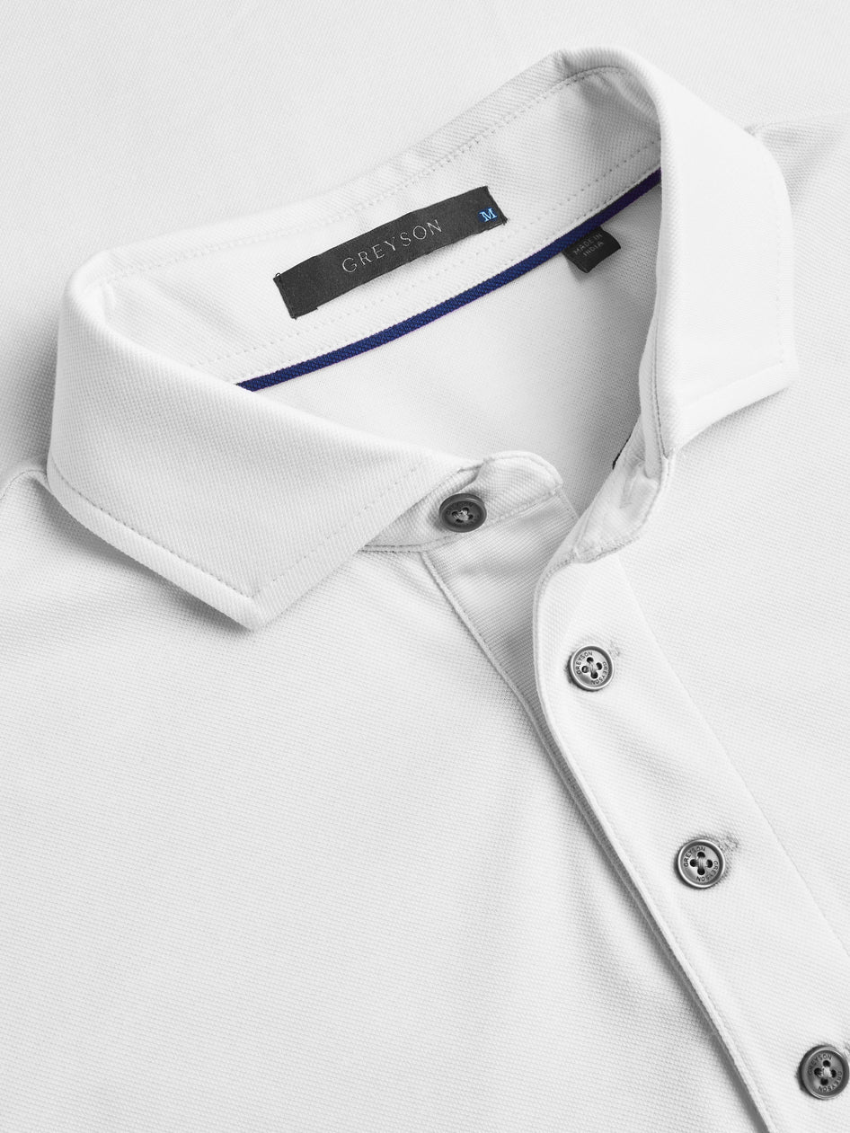 Close-up of a white dress shirt with a Crenson label on a light gray background