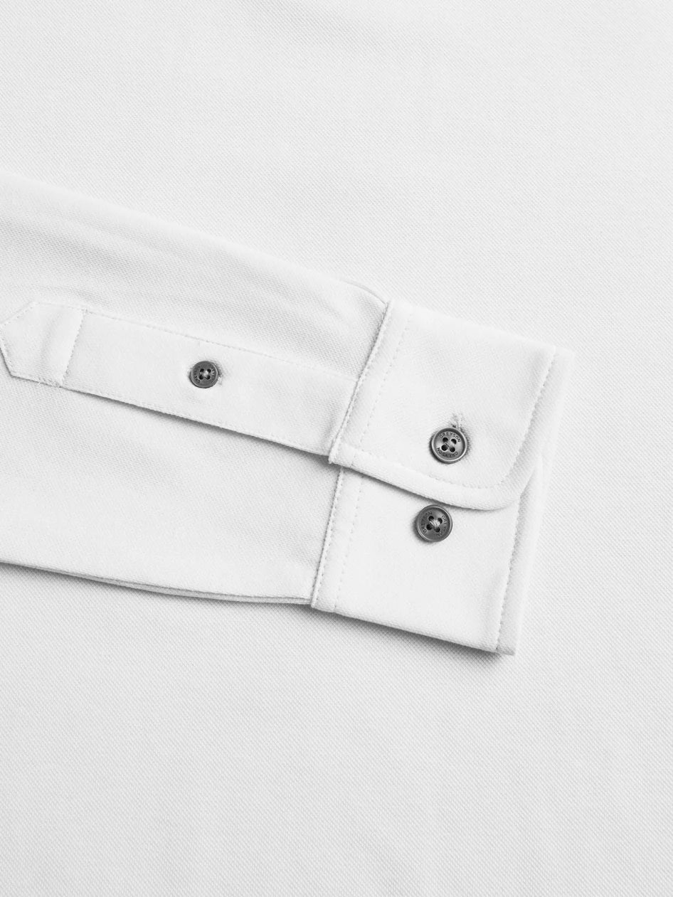 Close-up of a white shirt with buttons on a light gray background