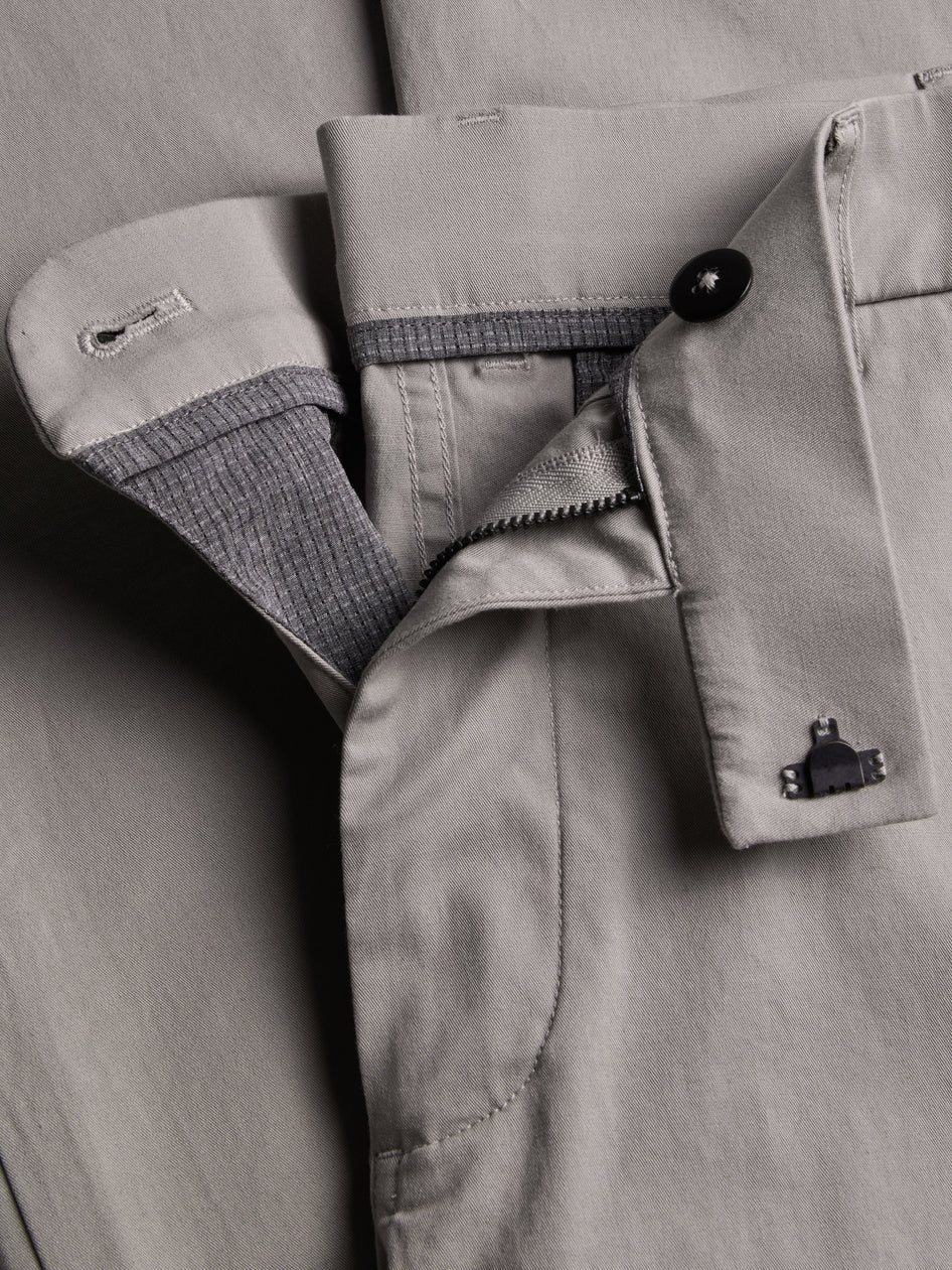 Close-up of a gray jacket with buttons and zippers