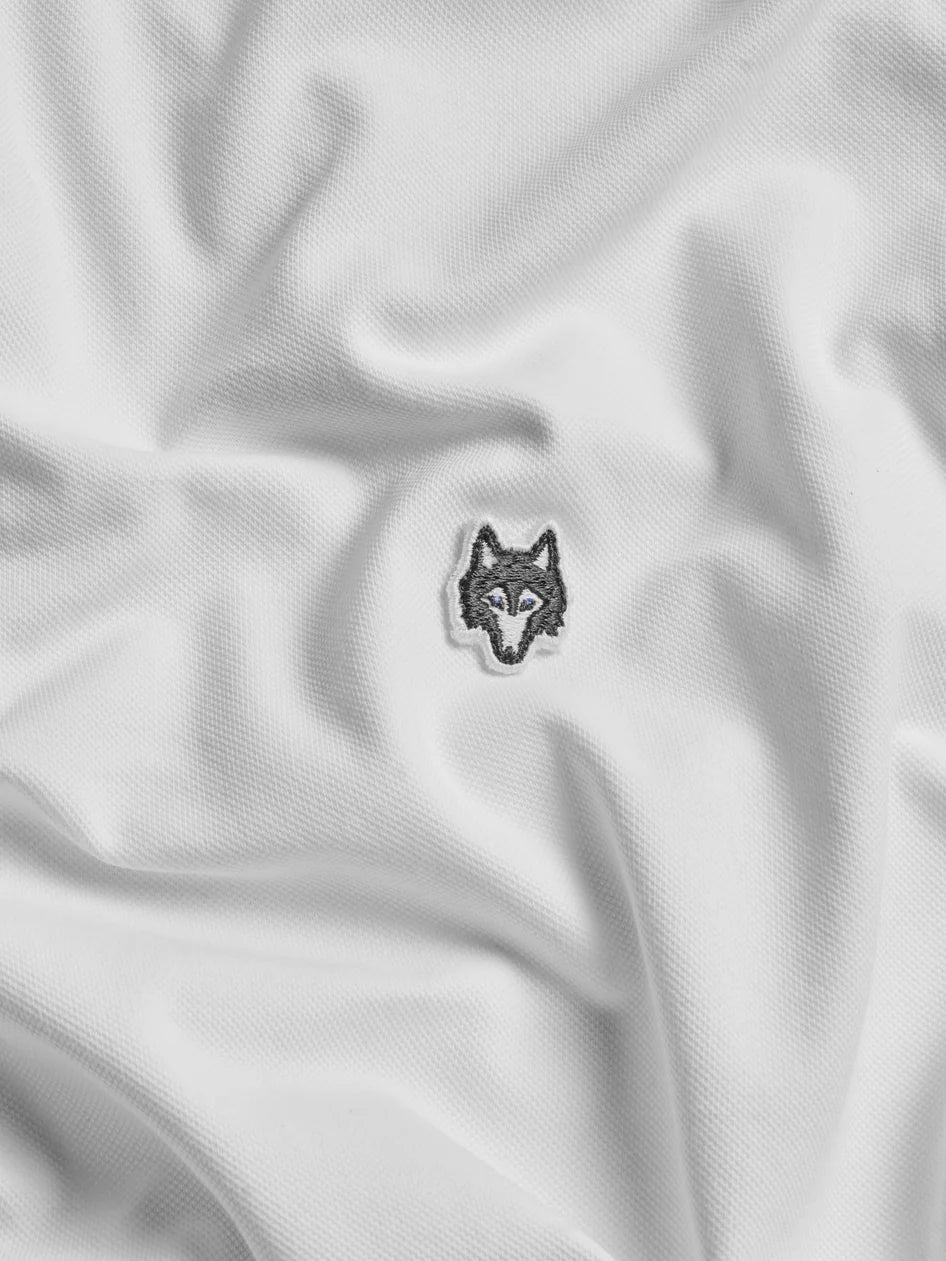 Wolf logo patch on a white fabric background