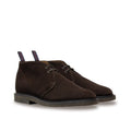 Pair of brown suede shoes on a white background